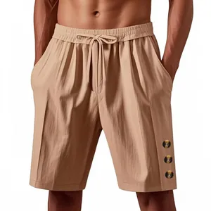 Detail view of men's loose linen-look shorts with drawstring waist and button accents