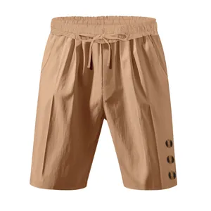 Detail view of camel linen-style men's shorts with drawstring waist and decorative buttons.