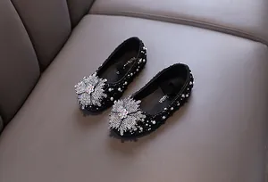Detailed top view of black girls' princess flats with silver rhinestones and pearls