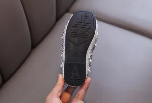 Detailed view of the durable non-slip rubber sole of silver rhinestone princess shoes