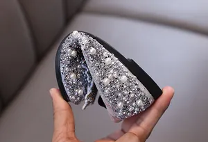 Close-up detail of flexible silver rhinestone princess shoes for girls showing soft sole