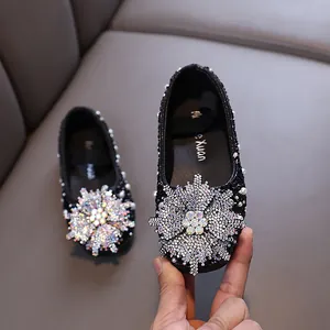 Elegant black princess flat shoes for girls featuring a sparkling rhinestone snowflake and pearls