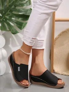 Fashionable women's black platform wedge sandals featuring open toe and white stitching detail