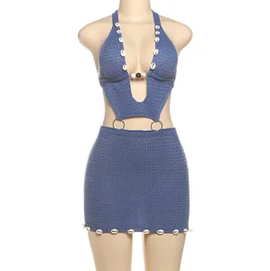 Detail view of the intricate knit pattern and shell accents on this sexy blue dress