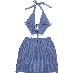 Detail showing the blue knit halter neck cut-out dress with stylish metal rings