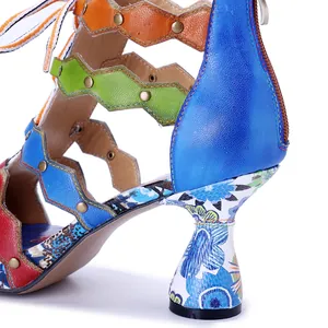 Close-up of bohemian leather sandal with colorful straps and floral pattern heel