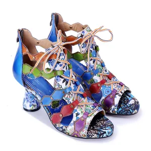 Colorful bohemian lace-up high heel sandals with floral patterns and leather details.