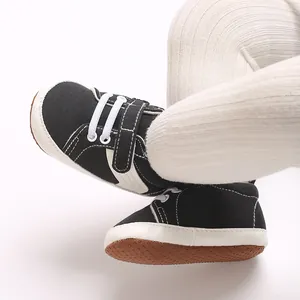 Close-up detail view of infant canvas sneakers with anti-slip soft soles on baby
