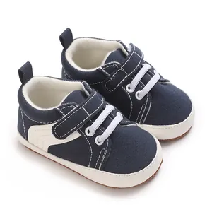 Close-up of navy blue canvas baby shoes with velcro strap and soft non-slip sole.