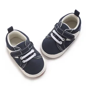 Close-up top view of navy blue baby sneakers with soft soles and velcro straps