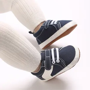 Detail of navy blue baby sneakers with white velcro strap and soft non-slip sole