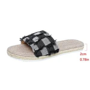 Close-up of 2cm heel height on denim checkered frayed strap flat slide sandals