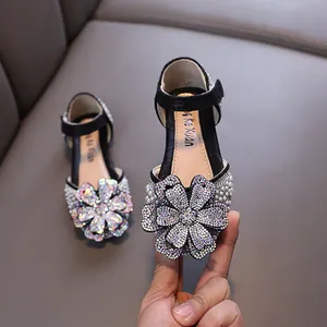 Elegant girls rhinestone princess shoes featuring a large sparkling floral crystal ornament