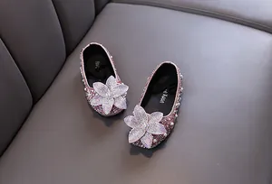 Sparkling pink girls princess shoes with large rhinestone flower detail for parties.