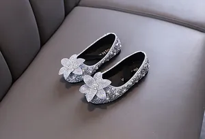 Close-up of silver girls princess flats with rhinestone flower and pearl details