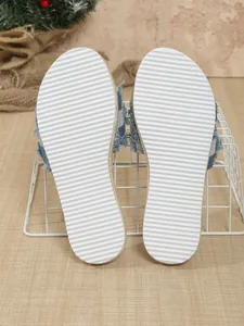 Macro detail view of white anti-slip traction soles on casual denim slippers for women