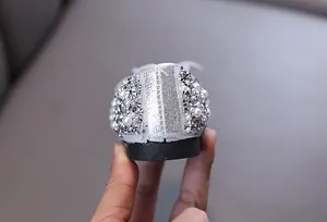Detail view of silver toddler princess shoe with rhinestones and pearl heel decoration
