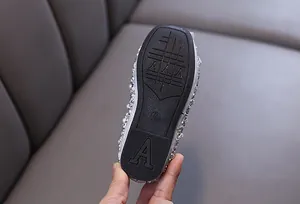 Close-up of the non-slip rubber outsole of a girls' rhinestone princess shoe.