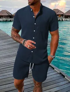 Men's navy blue textured 2-piece short sleeve shirt and shorts set on a beach boardwalk