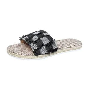 Stylish women's denim checkered flat slide sandals featuring frayed edges and woven sole