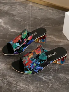 Elegante vista detallada de sandalias florales con tacones decorados con piedras