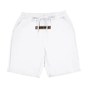 Detail of white breathable linen shorts for men with drawstring waist and patch.