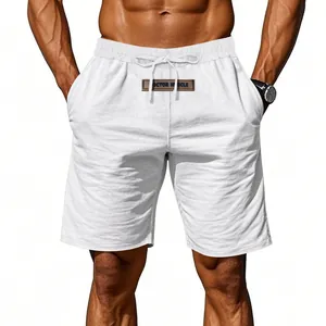 Detail view of breathable white drawstring linen shorts on a fit male model.