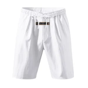 Close-up of breathable white linen men's shorts featuring drawstring waist and decorative label