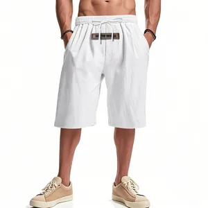 Detailed view of white men's linen drawstring shorts worn by a fitness model