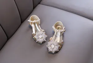 Close-up of elegant girl's princess shoes with snowflake rhinestones and pearls