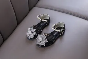 Elegant black princess shoes for girls featuring rhinestone flower and pearl buckle straps