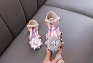 Close-up of pink girls' princess shoes featuring a large rhinestone snowflake ornament
