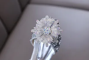 Detailed view of sparkling crystal flower on silver girl's princess dress shoe