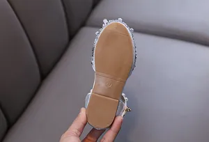 Close-up of non-slip rubber sole on silver rhinestone princess shoes for girls