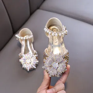 Sparkling gold girls' princess shoes with large rhinestone flower and pearl strap
