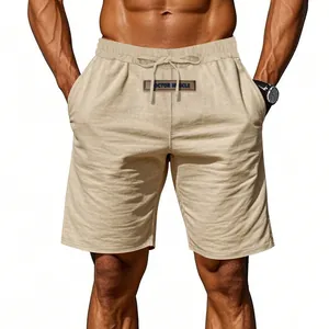Close-up of men's breathable linen shorts featuring a drawstring waist and decorative patch.