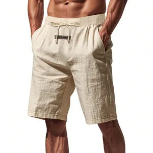 Detailed view of men's beige linen shorts with drawstring waist on muscular model