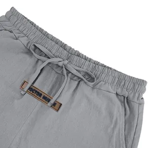 Detailed macro view of men's linen shorts showing elastic waistband and drawstring