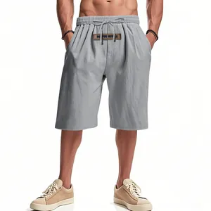 Detail view of the drawstring waist and grey linen fabric on men's relaxed fit shorts