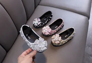 Detailed view of girls' rhinestone flower princess shoes in silver, gold, pink, and black