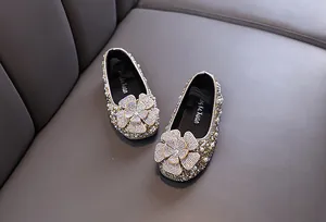 Detailed view of girls princess shoes decorated with sparkling rhinestones and pearls