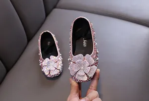 Detail of pink rhinestone princess shoes for girls with floral embellishments