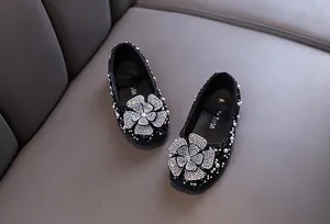 Elegant black girl's princess flats featuring a sparkling rhinestone flower detail