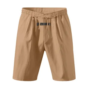 Close-up detail of men's summer khaki linen shorts with drawstring and brand label detail