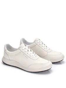 Detalle de vista lateral de zapatillas de cuero premium para hombre en blanco roto con suela blanda