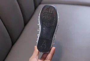 Close-up view of the textured non-slip rubber sole on girls' princess dance shoes
