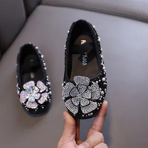 Elegant black princess shoes for girls with large rhinestone flowers and pearl accents