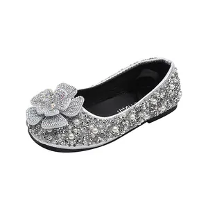 Sparkling silver girls princess shoes with rhinestones and flower applique for performances.