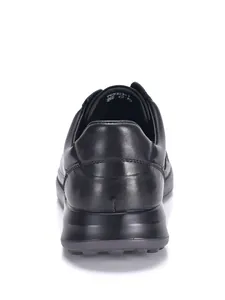 Vista trasera de zapatillas de cuero negro para hombre con suela blanda