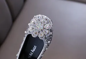 Sparkling silver girls' princess shoes with crystal flower detail and pearls.